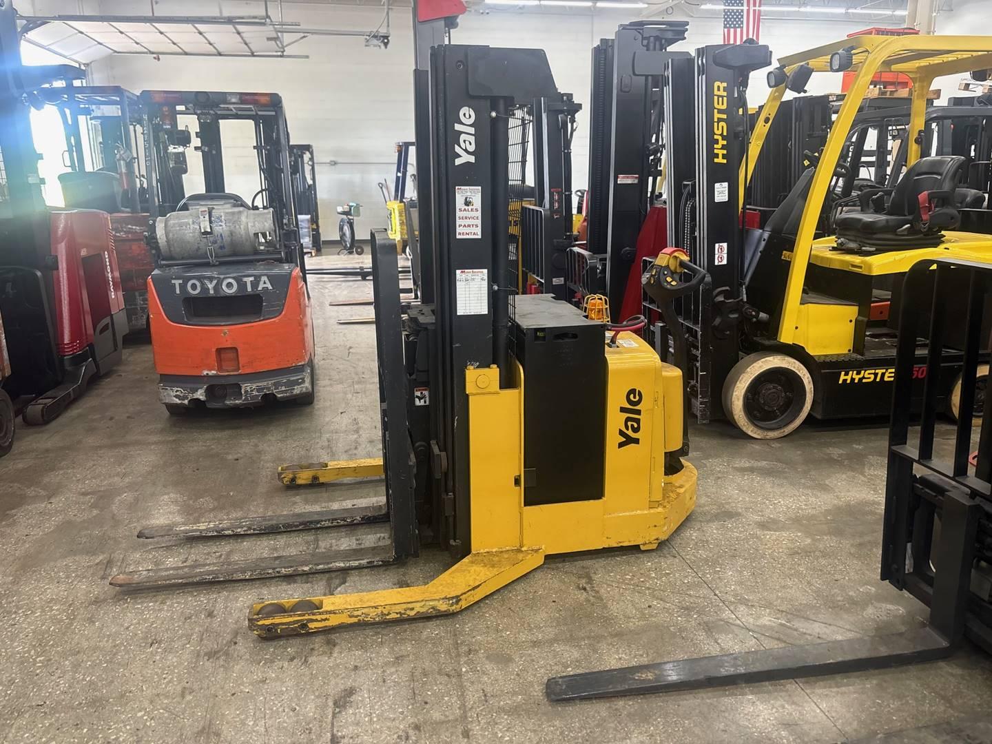 Multiple forklifts including Yale and Toyota inside warehouse