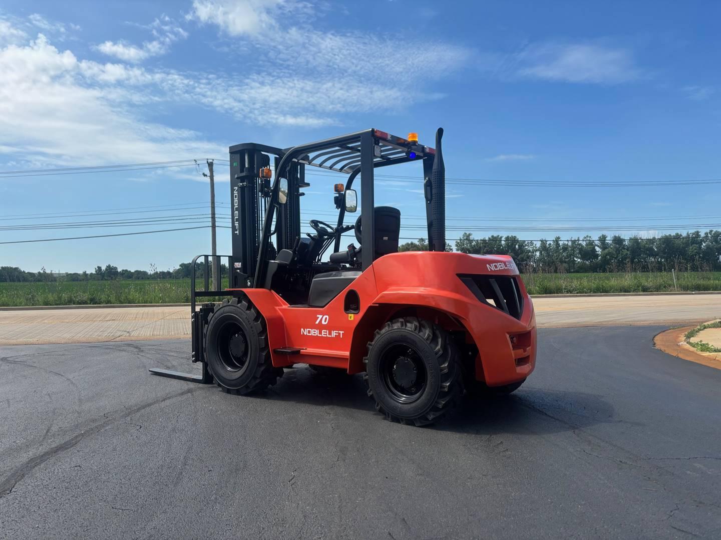 Red Noblelift forklift parked outdoors on pavement