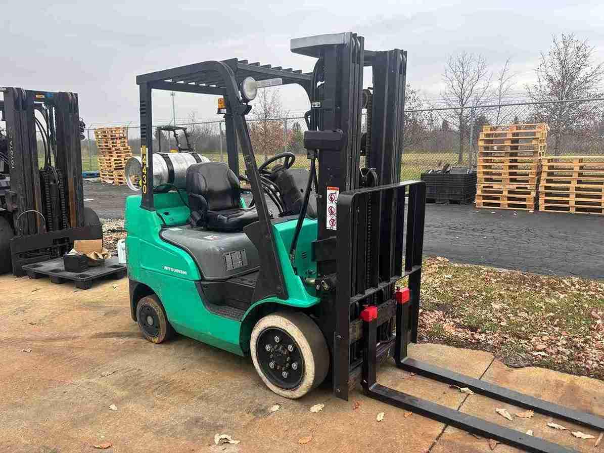 Green forklift in outdoor yard