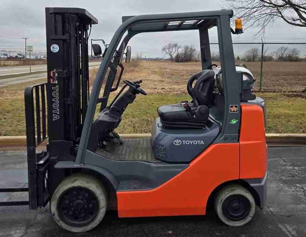 Orange forklift parked outdoors