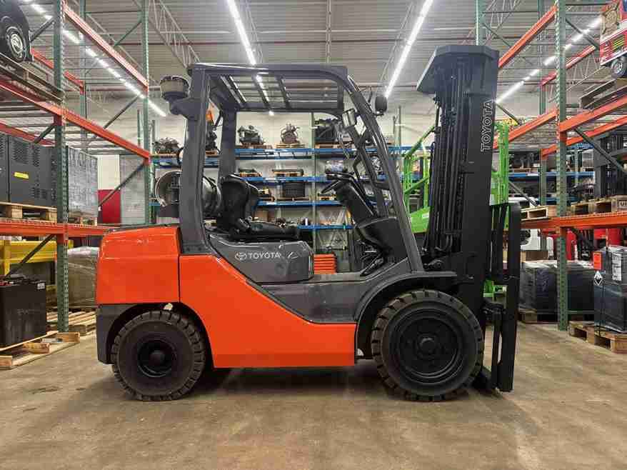 Orange forklift parked indoors